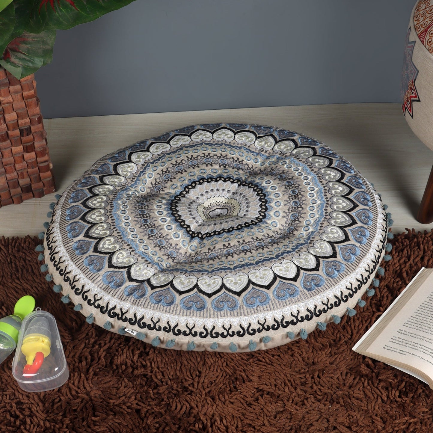 Taburete con cojín de piso y juego de almohadas.